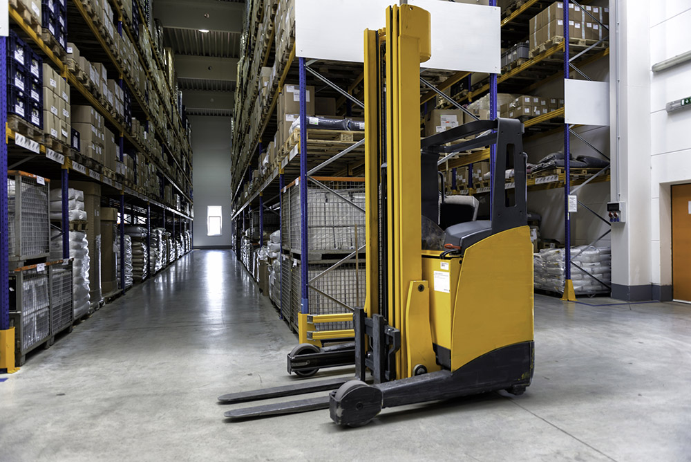 Yellow fork lift stopped in a warehouse